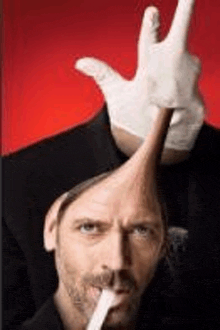 a man wearing a hat and gloves is making a peace sign .