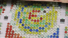 a bunch of marbles are arranged in a pattern with a green exit sign in the background