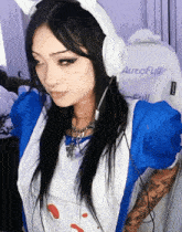 a woman wearing headphones and a blue and white outfit is sitting in a white autofull chair