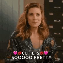 a woman is wearing a sequined jacket and earrings and says cutie is sooooo pretty .