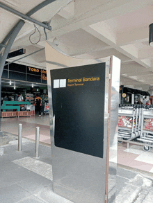 a sign that says terminal bandara on it in front of a store