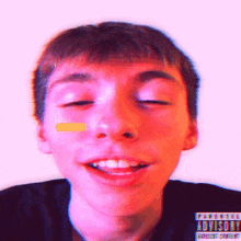 a close up of a boy 's face with a parental advisory label