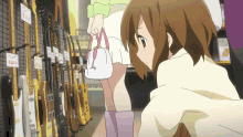 a girl in a white skirt is looking at guitars in a store with a sign that says ' yamaha '