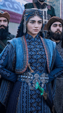 a woman in a blue dress holds a sword