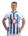 a man is wearing a blue and white striped soccer jersey with a red b on the front .