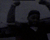 a man with his fist in the air is wearing a watch