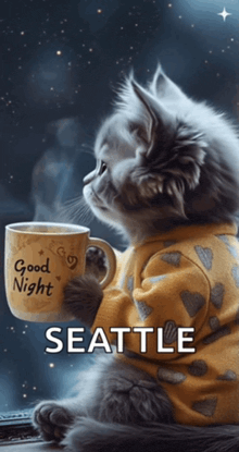 a kitten is holding a cup that says good night seattle
