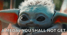 a close up of a baby yoda with the words `` a medal you shall not get '' written above it .