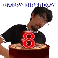 a man is blowing out a candle on a birthday cake with the number eight on it