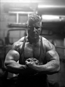 a black and white photo of a man with a harley davidson tank top