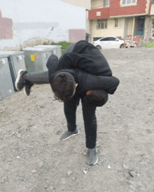 a man is carrying another man on his back in a dirt area