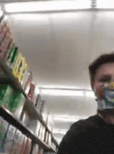 a man wearing a face mask is standing in a store .