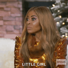 a woman in a gold sequined dress is making a funny face and says little girl .
