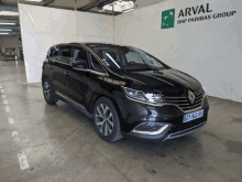 a car is parked in front of an arval bnp paribas group sign