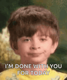 a young boy says i 'm done with you for today in front of a green background