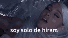 a woman in a white dress with the words soy solo de hiram below her