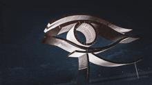 a large metal sculpture of an eye with a dark sky in the background