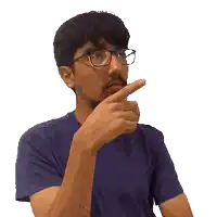 a man wearing glasses and a blue shirt is pointing his finger at his chin