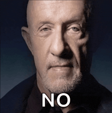 a man with a beard is looking at the camera and says no