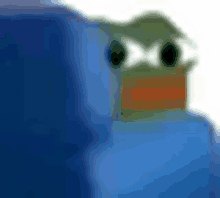 a blurred image of a frog sitting on top of a blue couch .