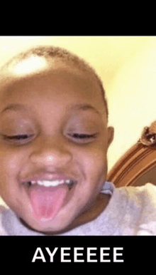 a young boy is sticking his tongue out and making a funny face with ayeeee written on the bottom