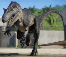 a gray and brown dinosaur with its mouth open and sharp claws