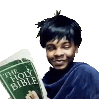 a young boy is holding a holy bible in his hand .