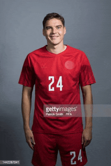 a soccer player poses for a picture during a portrait session .