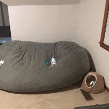 a dog laying on a bean bag in a room