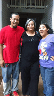 a woman wearing a purple shirt that says sushi poses with two other women