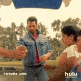 a man in a denim jacket is giving ice cream to a little girl in front of a sign that says future man