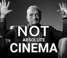 a man is sitting in a chair with his hands in the air and the words not absolute cinema behind him