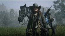 a woman wearing a cowboy hat stands next to a black horse