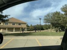 a group of people playing volleyball in a parking lot