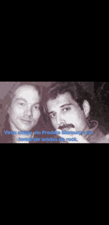 a black and white photo of two men standing next to each other