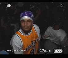 a video of a man wearing a bryant jersey is being recorded