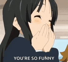 a girl with long black hair is covering her mouth with her hands and says `` you 're so funny '' .