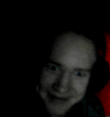 a blurry picture of a man 's face with headphones on