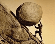 a statue of a man pushing a large rock up a hill