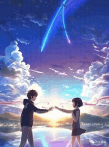 a boy and a girl are standing next to each other in front of a lake holding hands .