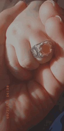 a person is holding a ring in their hand with the date 08/21/21