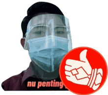 a man wearing a mask and a face shield with a thumbs up sign