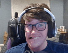 a man wearing glasses and headphones is smiling for the camera