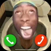 a man is sitting in a toilet talking on a cell phone with two buttons .