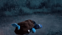 a stuffed animal is running in the rain with a blue tail