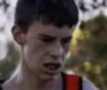 a close up of a man 's face with a backpack on .