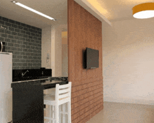 a kitchen with a brick wall and a flat screen tv