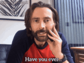 a man with a beard is talking on a cell phone with the caption " have you ever "
