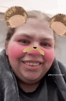 a woman with bear ears on her face is smiling for the camera