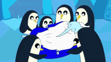 a group of penguins are holding a blue penguin in their arms